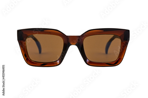 Brown colored bold square horn rimmed sunglasses with brown matte lenses and thick frames isolated on white background. Front view.
