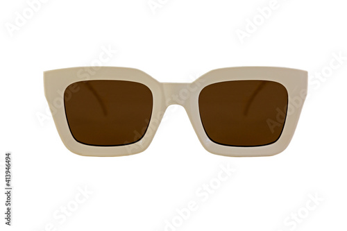 Beige colored bold square horn rimmed sunglasses with brown matte lenses and thick frames isolated on white background. Front view.