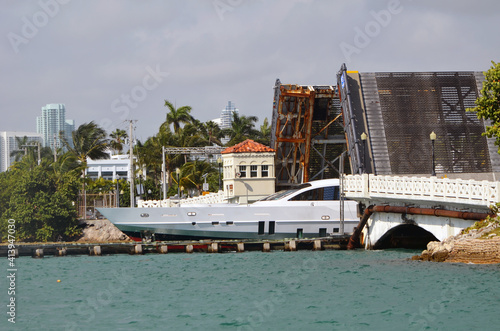 Motor yacht passing through an open drawbridge on the Venetia Causeway in Miami Beach,Florida.