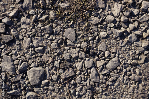 large and small gray stones are randomly scattered on the ground