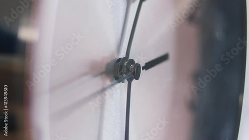 Close shot of clock hands ticking around a clock