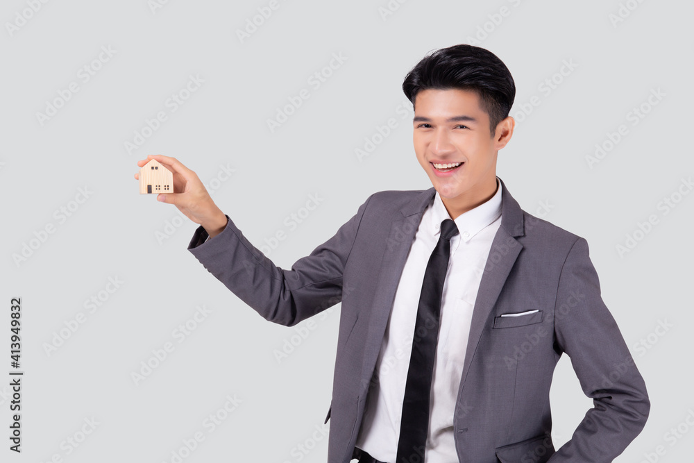 Young asian business man holding the home symbol of saving for future, insurance agent and credit, ownership house, debt and loan of finance, purchase home and refinance, investment real property. Young asian business man holding the home symbol of saving for future, insurance agent and credit, ownership house, debt and loan of finance, purchase home and refinance, investment real property.