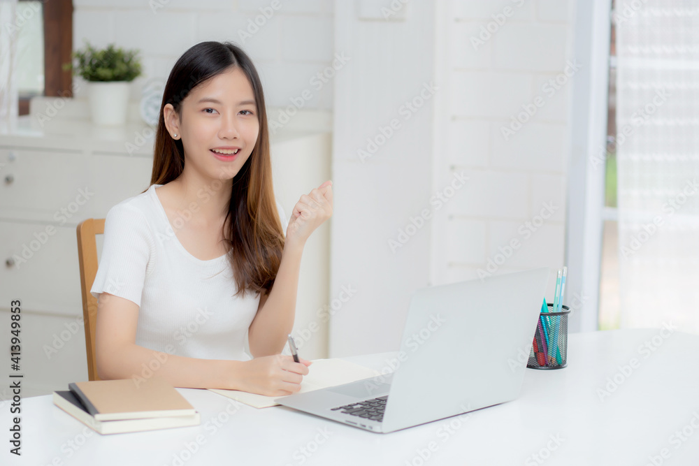Young asian woman confident working at home with laptop computer and thinking idea for planning, freelance happy girl excited and success using notebook thoughtful and writing, business concept. Young asian woman confident working at home with laptop computer and thinking idea for planning, freelance happy girl excited and success using notebook thoughtful and writing, business concept.