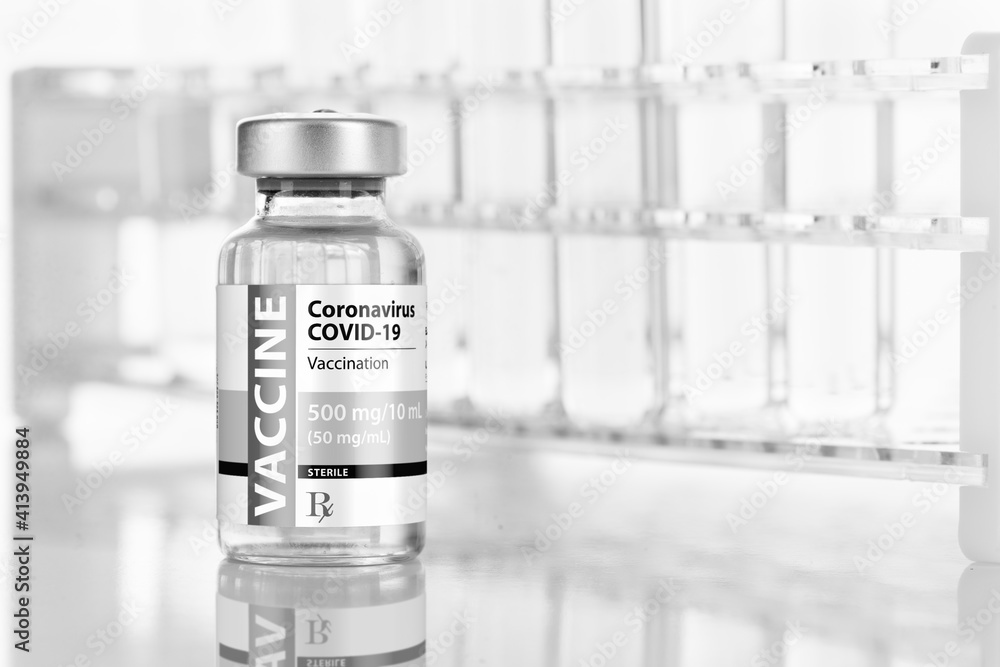 Coronavirus COVID-19 Vaccine Vial Near Test Tubes On Reflective Surface Coronavirus COVID-19 Vaccine Vial Near Test Tubes On Reflective Surface