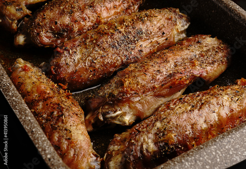 Turkey wings baked in the oven until golden brown with spices. Top view.