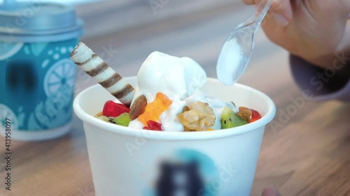 Delicious yoghurt ice cream with additives in a cafe close-up