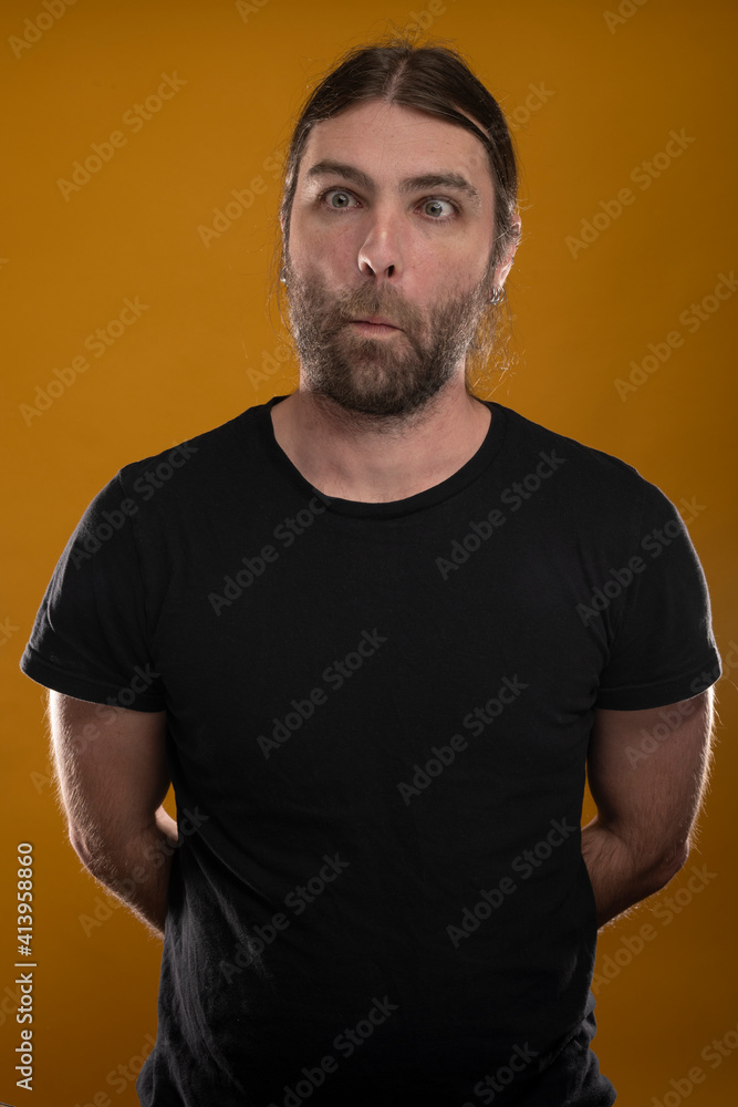 Obraz premium Funny male with long hair making faces to the camera and looking cross eyes.