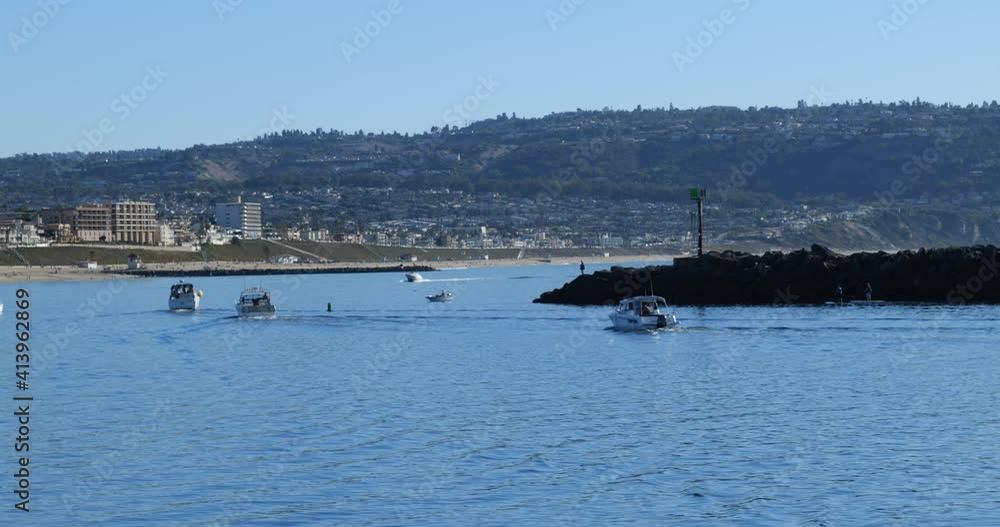 Boats rounding the breakwater into the Pacific Ocean at a vacation resort
Boats rounding the breakwater into the Pacific Ocean at a vacation resort
