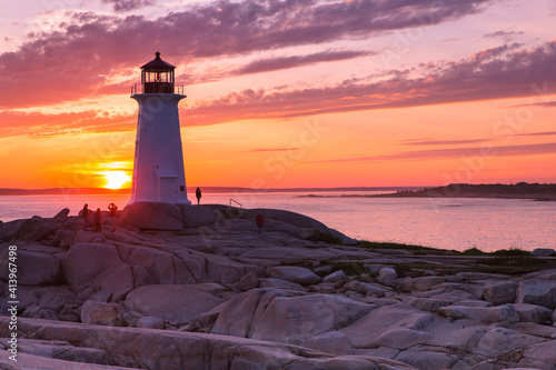 A dramatic sunset at Peggy's Cove Lighthouse Atlantic Coast Nova Scotia Canada. The most visited tourist location in the Atlantic Canada and famous Lighthouse captured with vibrant colors during sunse