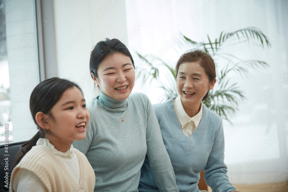Little kid daughter and old mother while sitting on sofa at home Little kid daughter and old mother while sitting on sofa at home