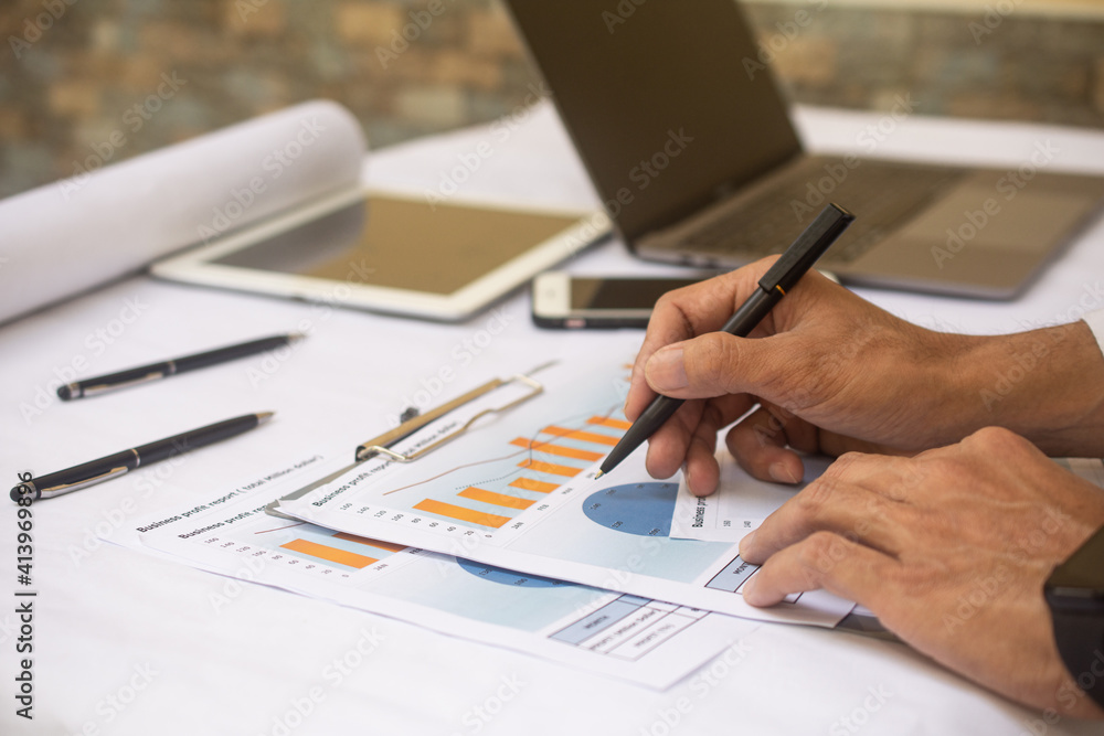 Hand working business profit report at workplace business office Hand working business profit report at workplace business office