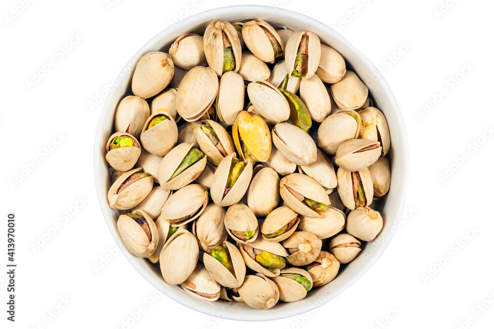 Pistachios in white porcelain bowls. Isolated food photo close up from above on white background Pistachios in white porcelain bowls. Isolated food photo close up from above on white background