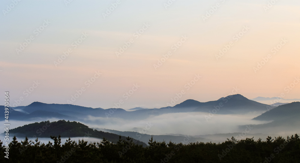 foggy mountain landscape at sunset