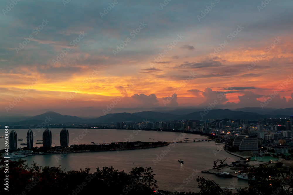 Beautiful sunset over the sea bay overlooking the city