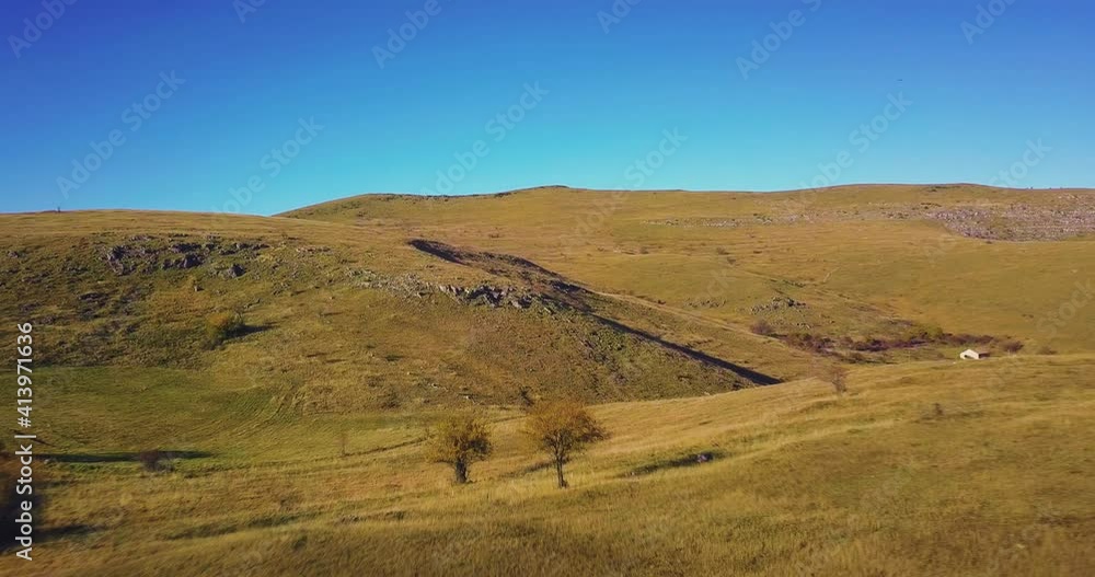 aerial view close to the ground of beautiful green meadow in the middle of nowhere