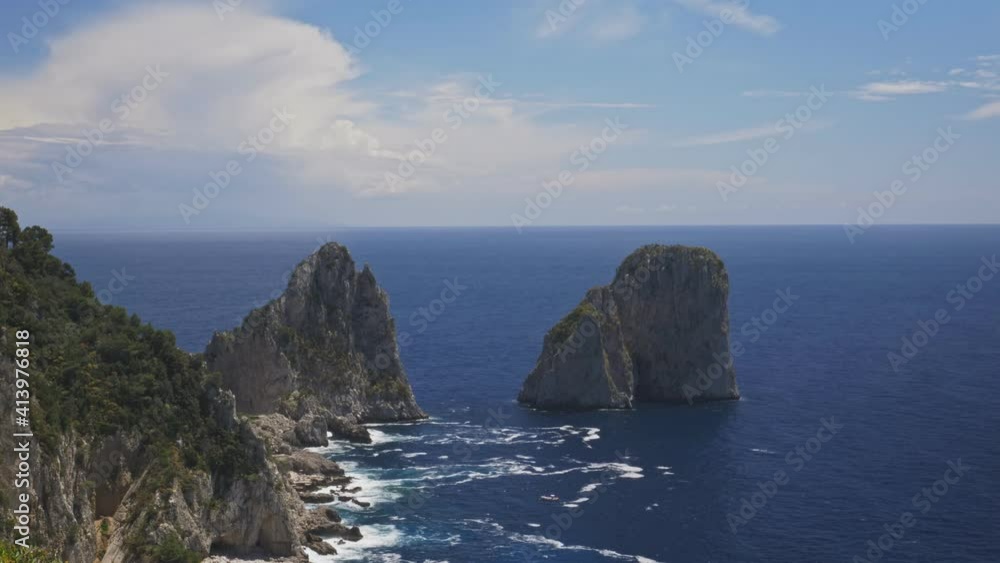 Small boats pass near Faraglioni in Capri during a sunny day, Timelapse Small boats pass near Faraglioni in Capri during a sunny day, Timelapse