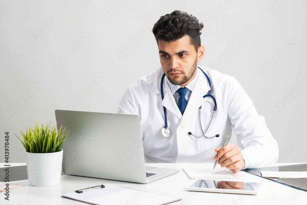 Young arab internist working at computer Young arab internist working at computer