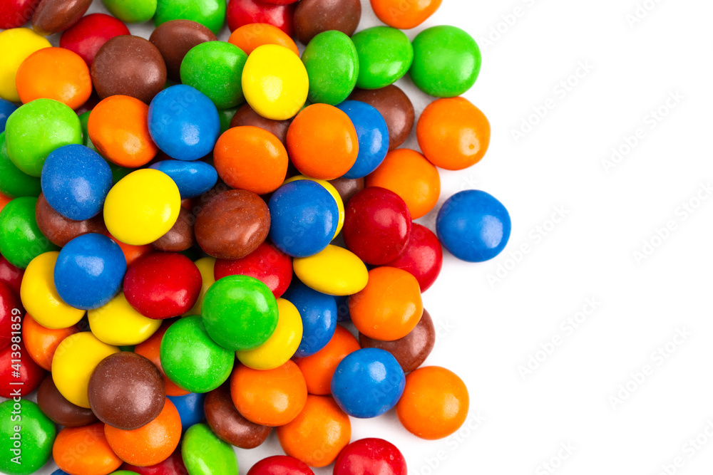 Pile of Rainbow Colored Candy Coated Chocolate Buttons Isolated on a White Background Pile of Rainbow Colored Candy Coated Chocolate Buttons Isolated on a White Background