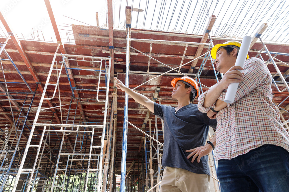 Construction concept of Engineer and Architect working at Construction Site with blue print Construction concept of Engineer and Architect working at Construction Site with blue print