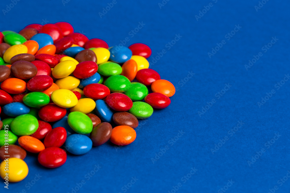 Pile of Rainbow Colored Candy Coated Chocolate Buttons Pile of Rainbow Colored Candy Coated Chocolate Buttons
