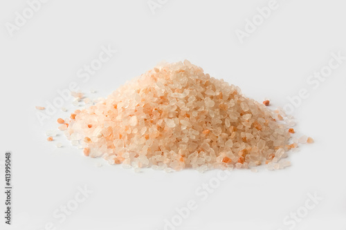 Pink red himalayan salt grain isolated white on the desk