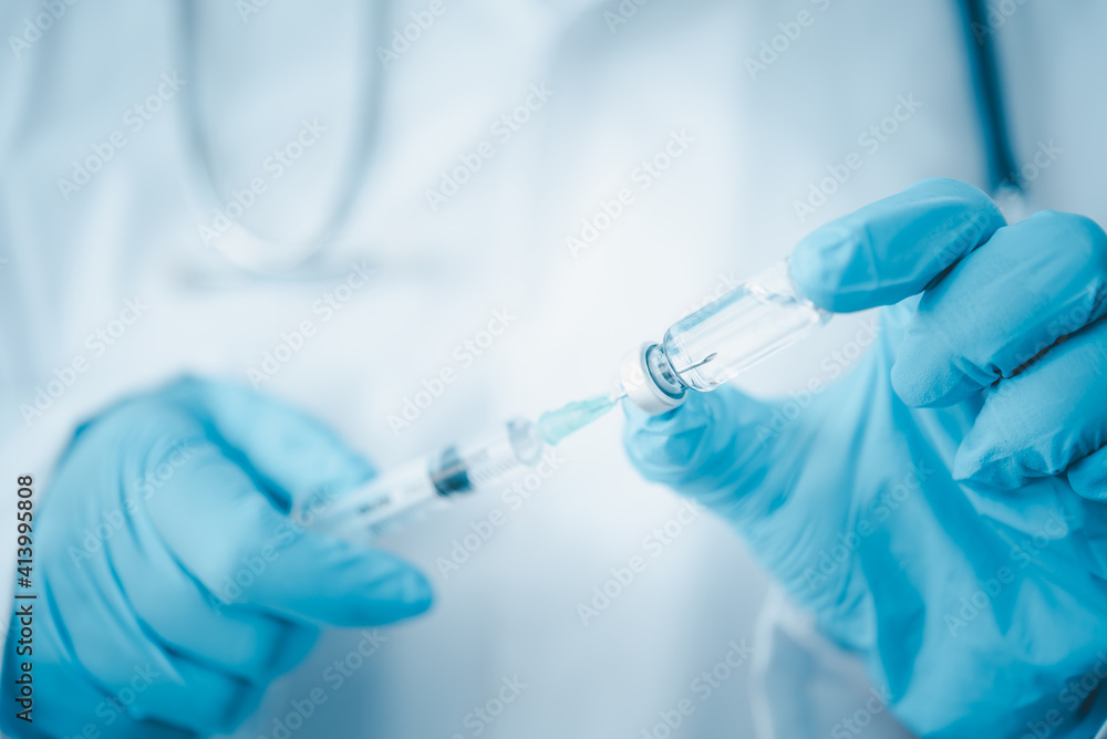 Doctor with syringe ready for injection of vaccine to patient. Vaccination concept.. Doctor with syringe ready for injection of vaccine to patient. Vaccination concept..