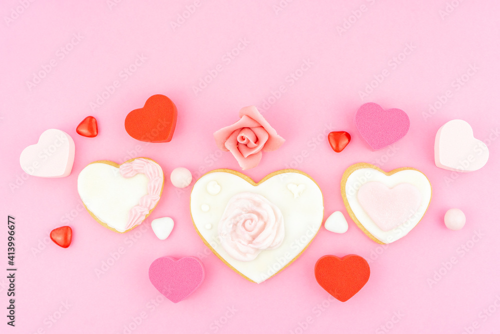 Heart shape pink, white and red cookies. Decorated heart shaped and rose cookies on pink background, flat lay with space for text. Marshmallow, Biscuit and Candy sweets. Valentine's day concept