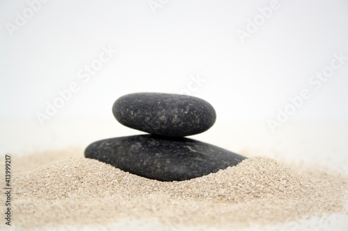 Sea round stones on the fine sand. Selective focus.
