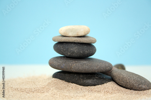 Sea round stones on the fine sand. Selective focus.