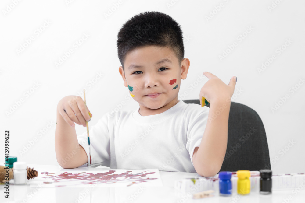 Happy little kid at the table draw with watercolor Learning and education of kid. Happy little kid at the table draw with watercolor Learning and education of kid.