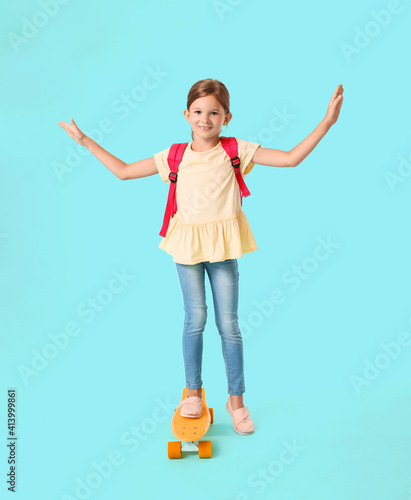 Happy little schoolgirl wit...