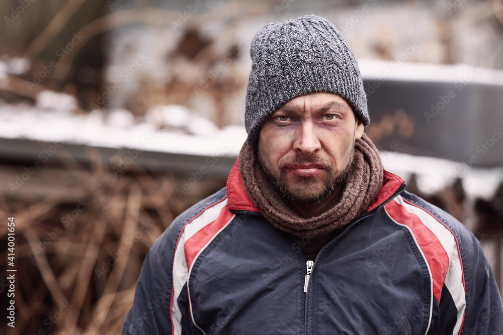 Poor homeless man outdoors on winter day Poor homeless man outdoors on winter day
