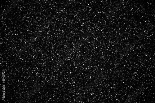 Falling realistic natural snowflakes on a black backgraund