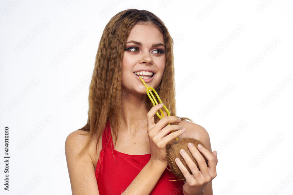 Woman with coconut in hands cocktail enjoying bright makeup Red t-shirt light background Woman with coconut in hands cocktail enjoying bright makeup Red t-shirt light background
