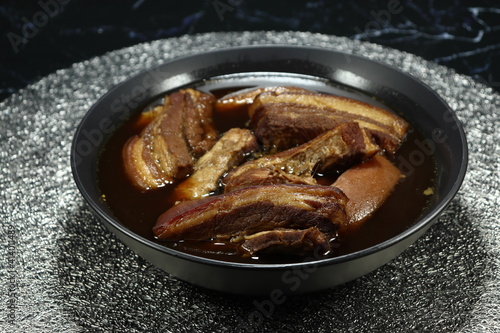 Traditional gravy soup of steamed pork belly with local herbal serving in the bowl. Famous menu in ancient ceremony or party in Asia. 