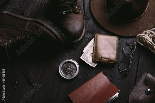 Flat lay of travel things on vintage wooden desk
