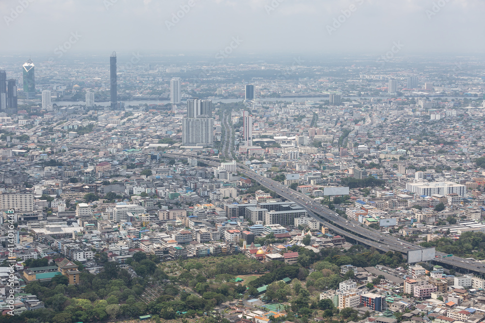 The view of Bangkok from the tallest building shows air pollution, dust, smoke. PM 2.5 Looking at the modern city mixed with temples, houses, old buildings and River
