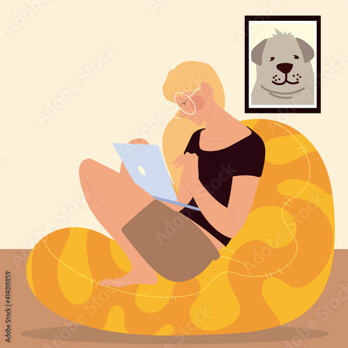 woman sitting on the bean chair working on laptop, work at home