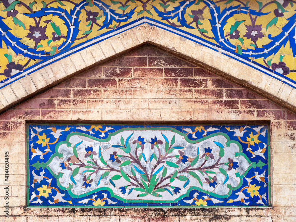 Beautiful kashi-kari or faience tile mosaic floral and geometric design on ancient mughal era Wazir Khan mosque in the walled city of Lahore, Punjab, Pakistan