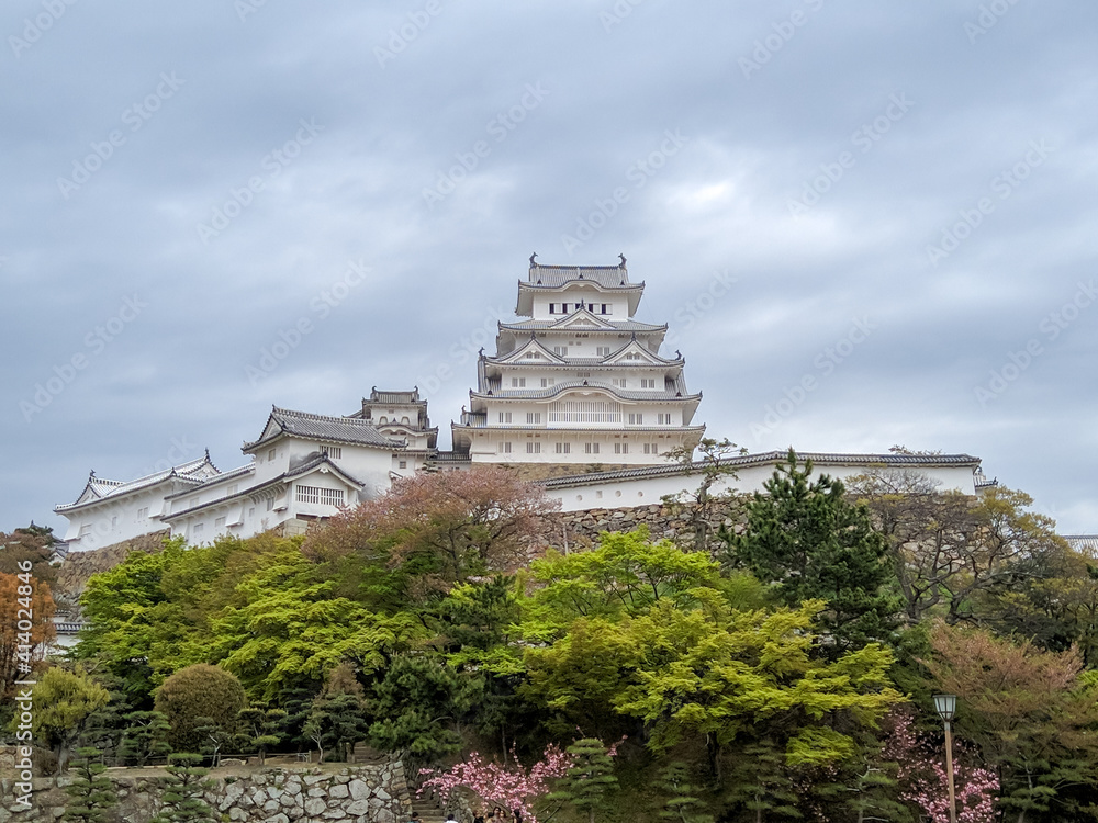 HIMEJI, JAPAN - APRIL 15, 2018: Himeji Shirasagijo Castle in the Japanese city of Himeji. The large white castle stands on a hill and is surrounded by a parkland. HIMEJI, JAPAN - APRIL 15, 2018: Himeji Shirasagijo Castle in the Japanese city of Himeji. The large white castle stands on a hill and is surrounded by a parkland.