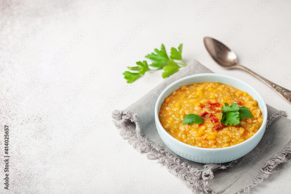 Homemade peas lentil soup with pepper and parsley in bowl on a table. Indian Dahl Homemade peas lentil soup with pepper and parsley in bowl on a table. Indian Dahl