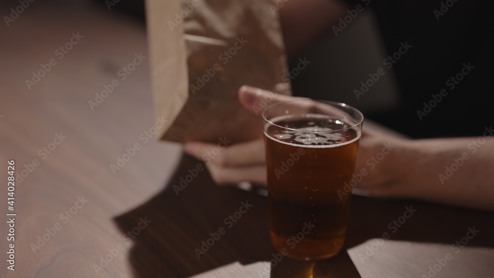Man drink apple cider with chips on walnut table Man drink apple cider with chips on walnut table