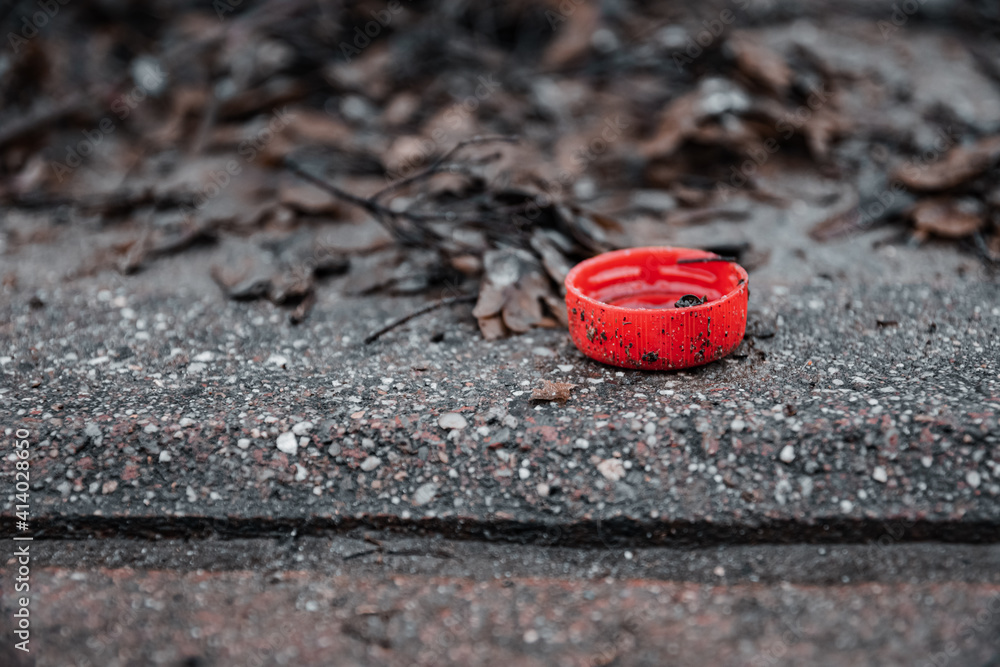 a drink lid as a drop on the road a drink lid as a drop on the road
