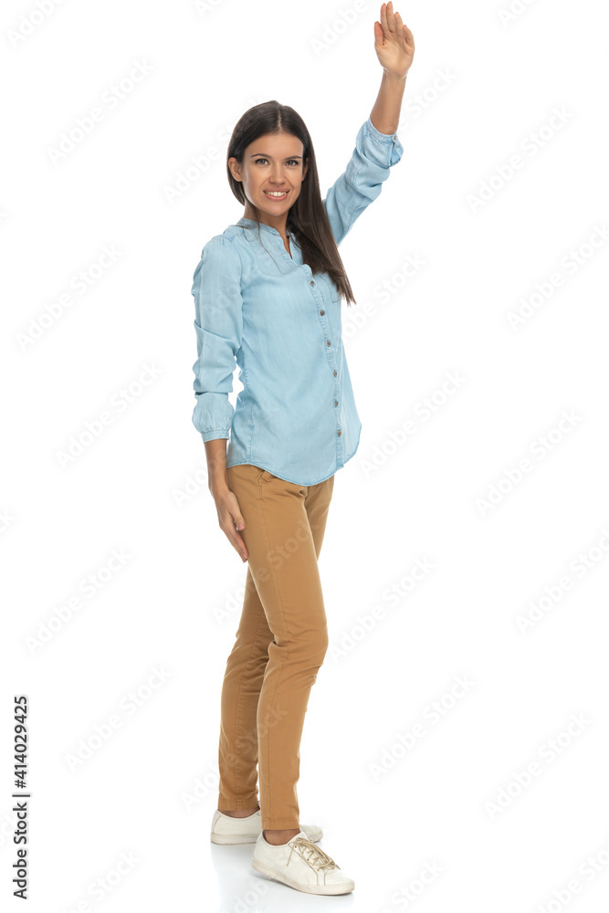 casual woman raising one hand waiting to say something casual woman raising one hand waiting to say something