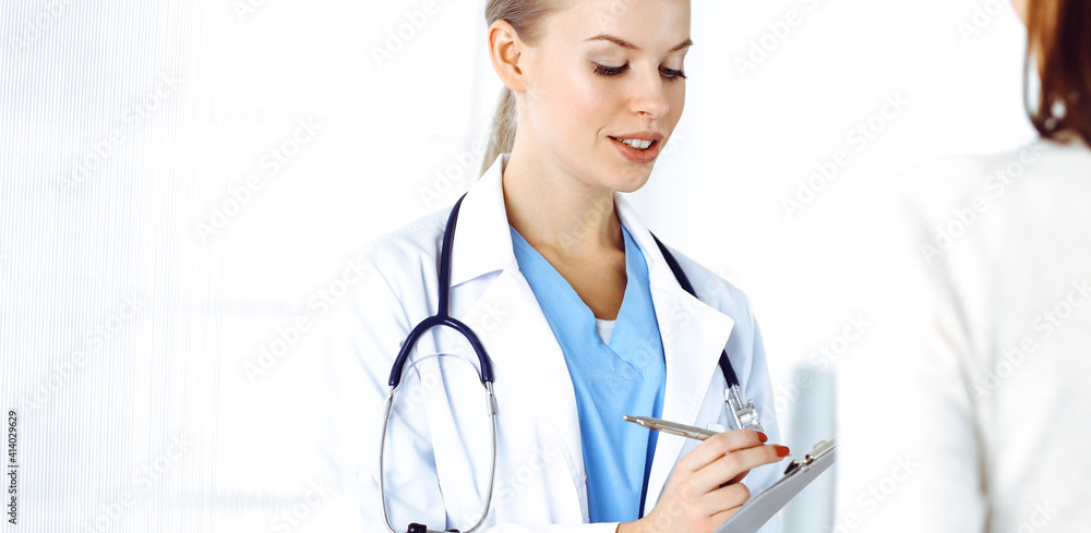 Woman - doctor consults her female patient while using clipboard and medication history record. Medicine concept Woman - doctor consults her female patient while using clipboard and medication history record. Medicine concept