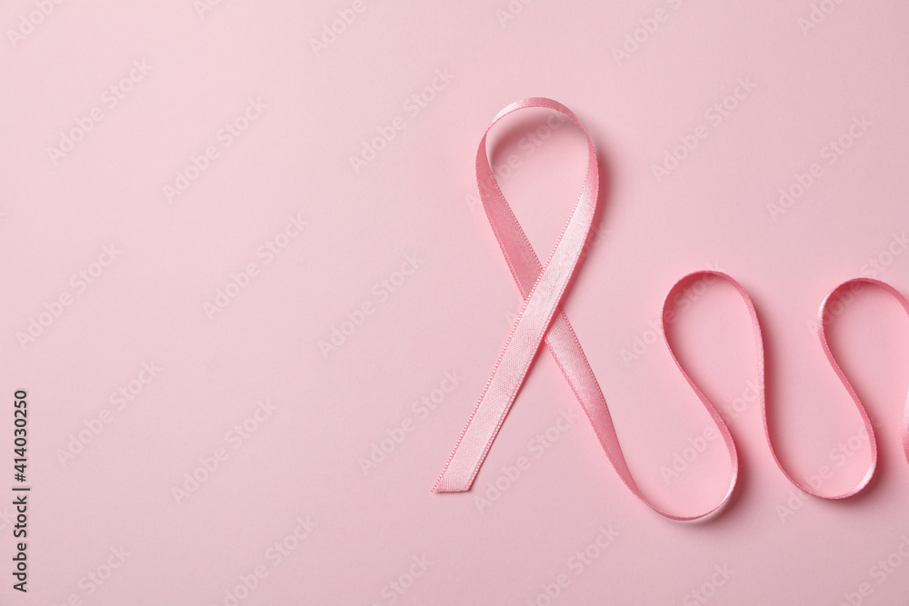 Pink awareness ribbon on pink background, space for text Pink awareness ribbon on pink background, space for text