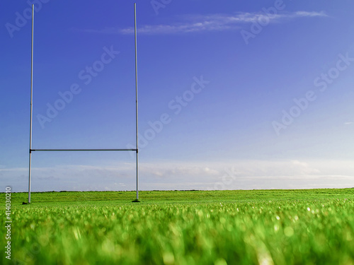Irish sport tall goal posts in a field on a bright sunny day. Galway city, Ireland. South park. Camogie, hurling and rugby training ground. Blue cloudy sky. Selective focus © mark_gusev