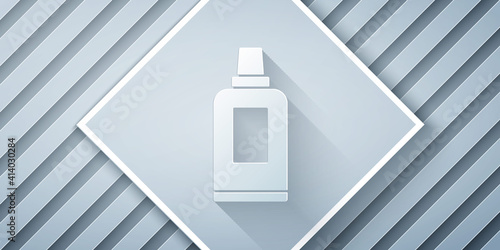 Paper cut Plastic bottle for laundry detergent, bleach, dishwashing liquid or another cleaning agent icon isolated on grey background. Paper art style. Vector.