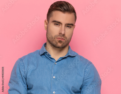 young casual fashion man in denim shirt posing