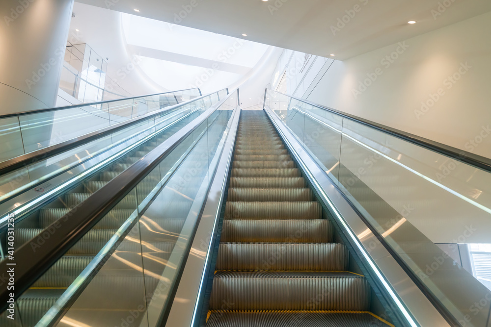 The escalator is in the mall The escalator is in the mall